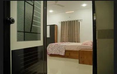 a bedroom with a bed and a window at Dhara Dhvani Getaway Homes in Tindummal