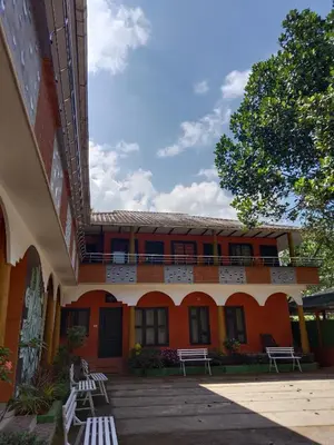 a building with benches in front of it at JUNGLE VALLEY AYURVEDIC SPa RESORT in Meppādi