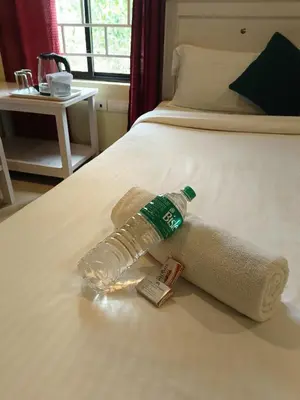 a plastic bottle on a bed in a room at JUNGLE VALLEY AYURVEDIC SPa RESORT in Meppādi