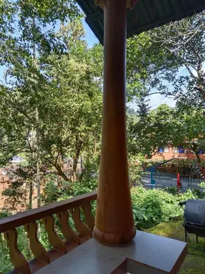 a pillar on a balcony with a view of a park at JUNGLE VALLEY AYURVEDIC SPa RESORT in Meppādi