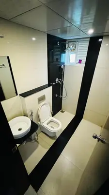a small bathroom with a toilet and a sink at Transit suites by Habitat in Cochin