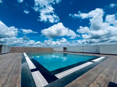 a swimming pool on the roof of a building at Transit suites by Habitat in Cochin