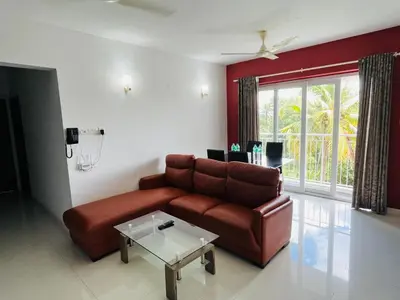 a living room with a couch and a table at Transit suites by Habitat in Cochin