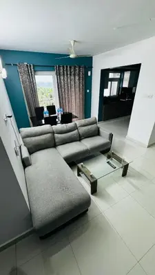 a living room with a couch and a table at Transit suites by Habitat in Cochin