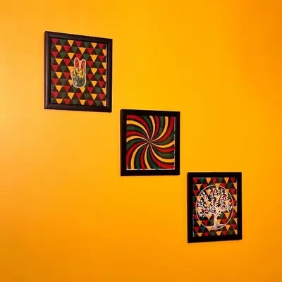 four pieces of art on a yellow wall at Rastafari - The Backpackers Hostel in Ooty
