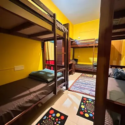 a room with two bunk beds and two remotes at Rastafari - The Backpackers Hostel in Ooty