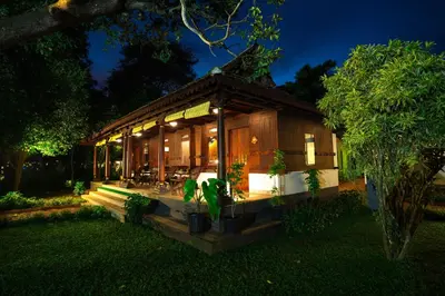 a small house with a lot of plants in the yard at Vedic Village Retreat Kodungallur in Cochin