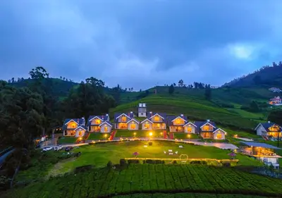 a large house on top of a hill at night at AJ Gable Clouds Ooty by VOYE HOMES - Serene Stay Near Avalanche Emerald Lake in Ooty