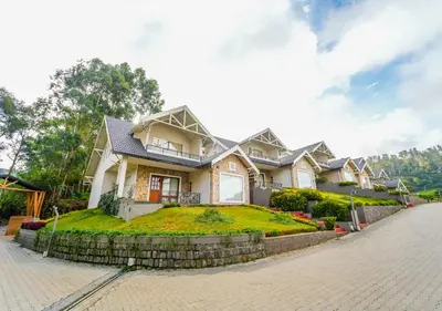 a house with a green lawn in front of it at AJ Gable Clouds Ooty by VOYE HOMES - Serene Stay Near Avalanche Emerald Lake in Ooty