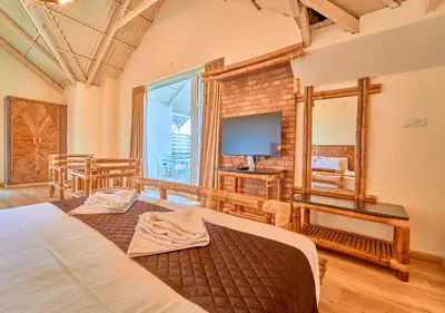 a bedroom with a large bed and a television at AJ Gable Clouds Ooty by VOYE HOMES - Serene Stay Near Avalanche Emerald Lake in Ooty