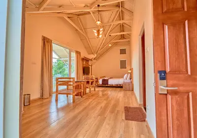 a room with a dining room and a bedroom at AJ Gable Clouds Ooty by VOYE HOMES - Serene Stay Near Avalanche Emerald Lake in Ooty