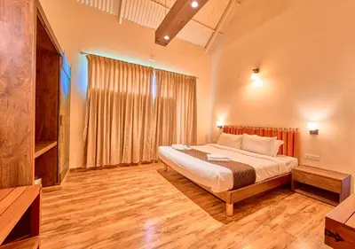 a bedroom with a large bed and a large window at AJ Gable Clouds Ooty by VOYE HOMES - Serene Stay Near Avalanche Emerald Lake in Ooty