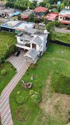 an aerial view of a house with a yard at Bridge Point Home Stay in Kushālnagar