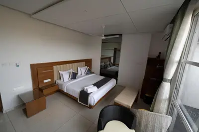 a hotel room with a bed and a chair at S R Private Residence in Mysore