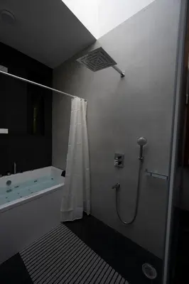 a bathroom with a shower with a shower curtain at S R Private Residence in Mysore