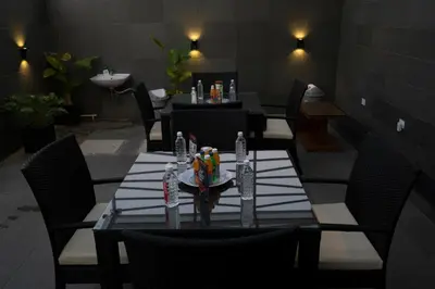 a dining room with a table and chairs with a candle on it at S R Private Residence in Mysore