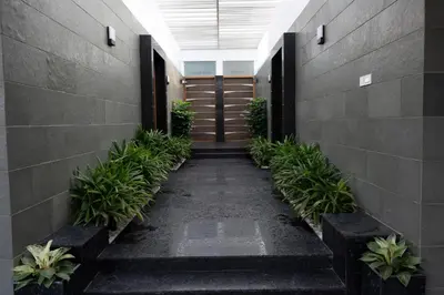 a hallway in a building with plants and doors at S R Private Residence in Mysore