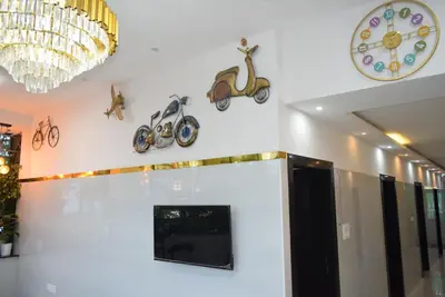 a room with a wall with clocks on the wall at M Grand Stay in Coimbatore