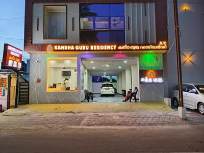 a building with a garage with a car parked in it at Kandhaguru Residency in Palani