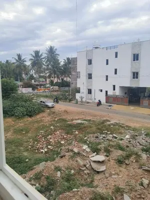a view from a window of a street with a building at Kandhaguru Residency in Palani