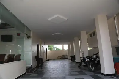 a hallway with a motorcycle parked in a building at Kandhaguru Residency in Palani