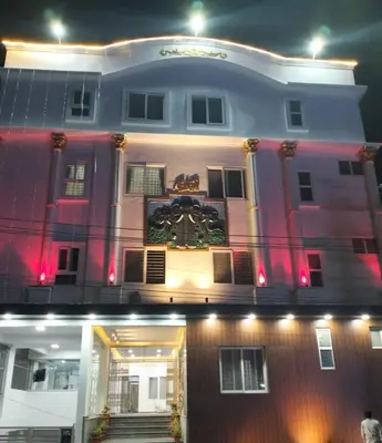 a building with a clock on the front of it at Amma Inn Elegance Suites and Apartments in Mysore