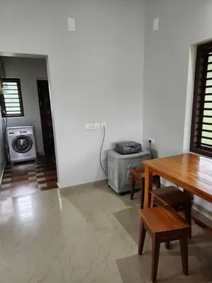 a living room with a table and a stove at Padua Building in Irrity