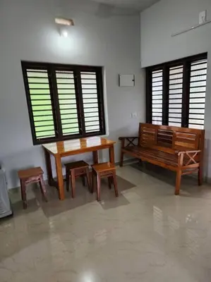 a room with a table and benches and windows at Padua Building in Irrity