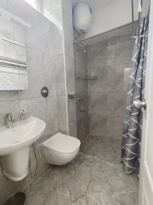 a bathroom with a toilet and a sink and a shower at 7 Elysee Homestay - Onyx - Premium 3BHK Family Flat in Trichūr