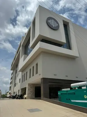 a building with a sign on the side of it at Royal Embassy in Erode