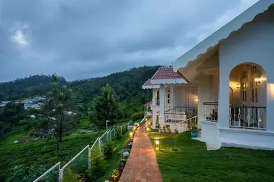 a house with a view of a hill at LohonoStays Villa Lansdowne in Coonoor