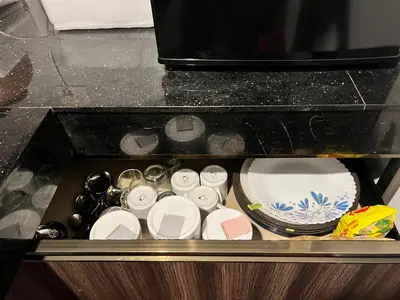 a drawer filled with cups and dishes in a kitchen at Gangadharam Tiny House 2BHK AC in Tellicherry