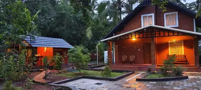 a small house with a patio in front of it at Gangadharam Tiny House 2BHK AC in Tellicherry