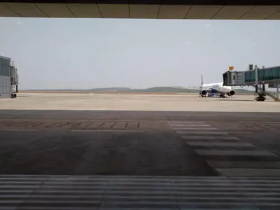 an airplane is sitting on the runway at an airport at Gangadharam Tiny House 2BHK AC in Tellicherry