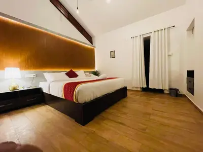 a bedroom with a large bed in a room at Drey at Druv Dakshin Farm Resort in Padinjarathara