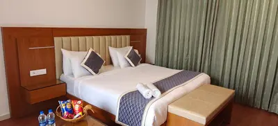 a hotel room with a bed with towels on it at S R Luxury Stays in Mysore