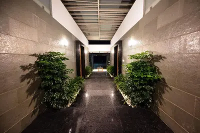 an empty hallway with plants in a building at S R Luxury Stays in Mysore