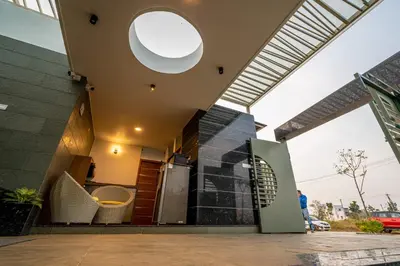 a house with a large window and a building at S R Spa Suites in Mysore