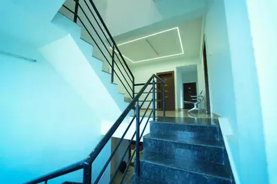 a staircase in a house with blue ceilings at GLN Residency Pure Veg in Kālvādi