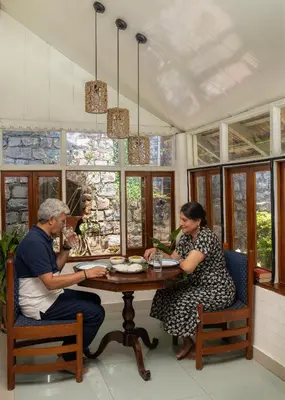 a man and a woman sitting at a table at The Anexure - Great Estate Stay for Remote Work in Siddapur
