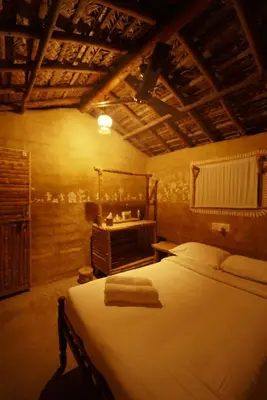 a bedroom with a bed with towels on it at The Soul Marayoor Mudhouse - Munnar in Marayoor