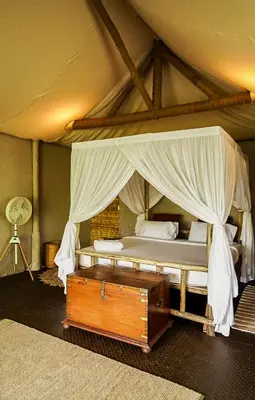 a bedroom with a large bed with a canopy at The Soul Marayoor Mudhouse - Munnar in Marayoor