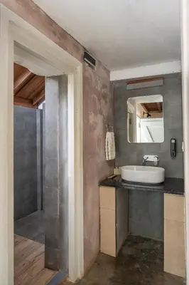 a bathroom with a sink and a mirror at Tool House - Great Estate Stay for Remote Work in Siddapur