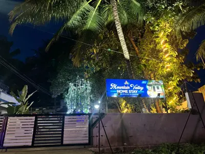 a sign for a pineapple park pineapple show at night at Mountain valley in Attappādi