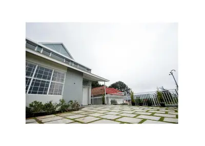 a house with a stone driveway in front of it at Haze cottage- MA Cottage in Ooty
