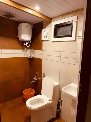 a bathroom with a toilet and a sink at Hill View 'A'Frame Villa Wayanad in Vythiri
