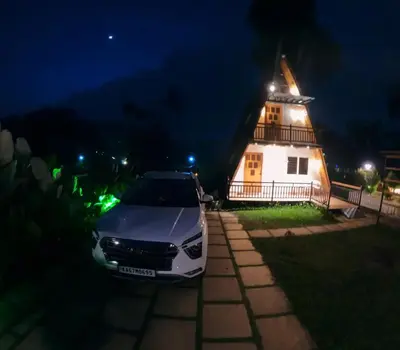 a car parked in front of a house at night at Hill View 'A'Frame Villa Wayanad in Vythiri