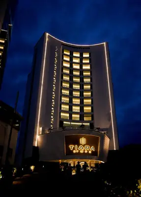 a tall building with a sign in front of it at TIARA by MPS in Kozhikode