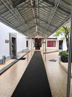 a hallway of a building with a walkway at Maharani Hotel in Kozhikode
