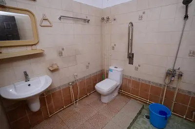 a bathroom with a toilet and a sink at Illam Heritage inn Bungalow l 4 BHK in Guruvāyūr
